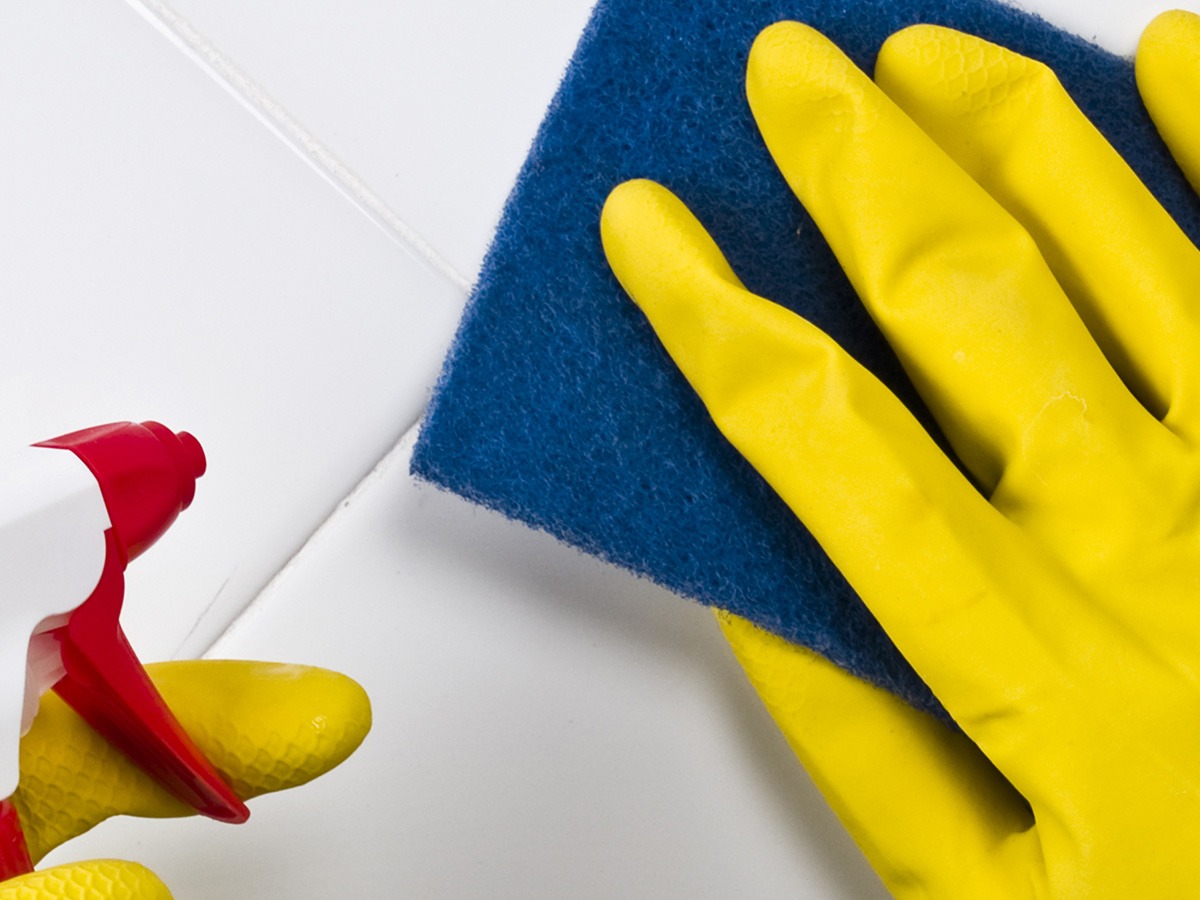 Image of a person scrubbing tile